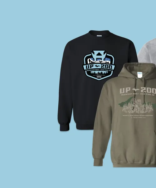 Three sweatshirts on a light blue background: a black one with a logo, a gray hoodie with a logo, and a green hoodie with text and graphics. All garments feature designs related to the "UP 200.